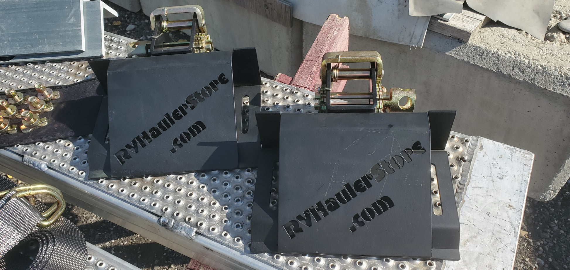 Metal wheel chocks with 'RVHaulerStore.com' branding on ramps