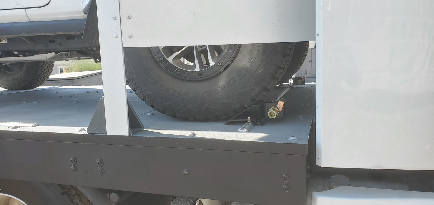 Close-up of a truck bed with a tire and metal frame