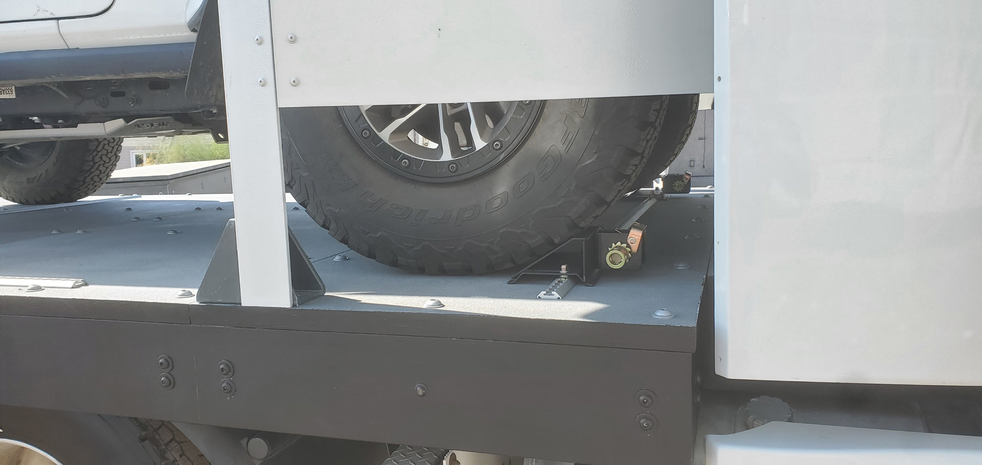Close-up of a truck bed with a tire and metal frame